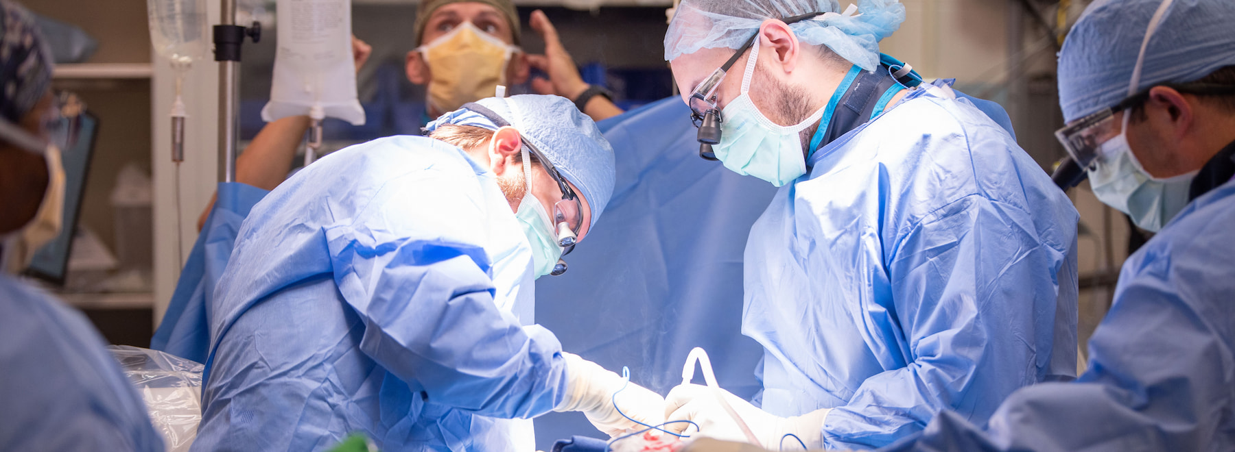 Two neurosurgery residents performing neurosurgical treatment in the OR.